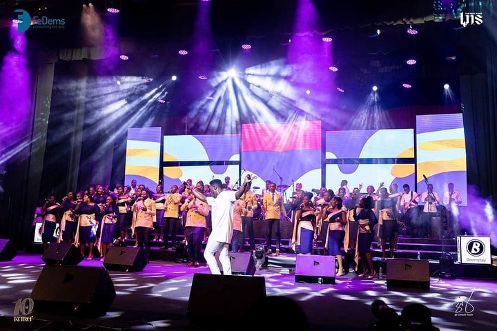 Concert stage with a large screen facing a seated audience