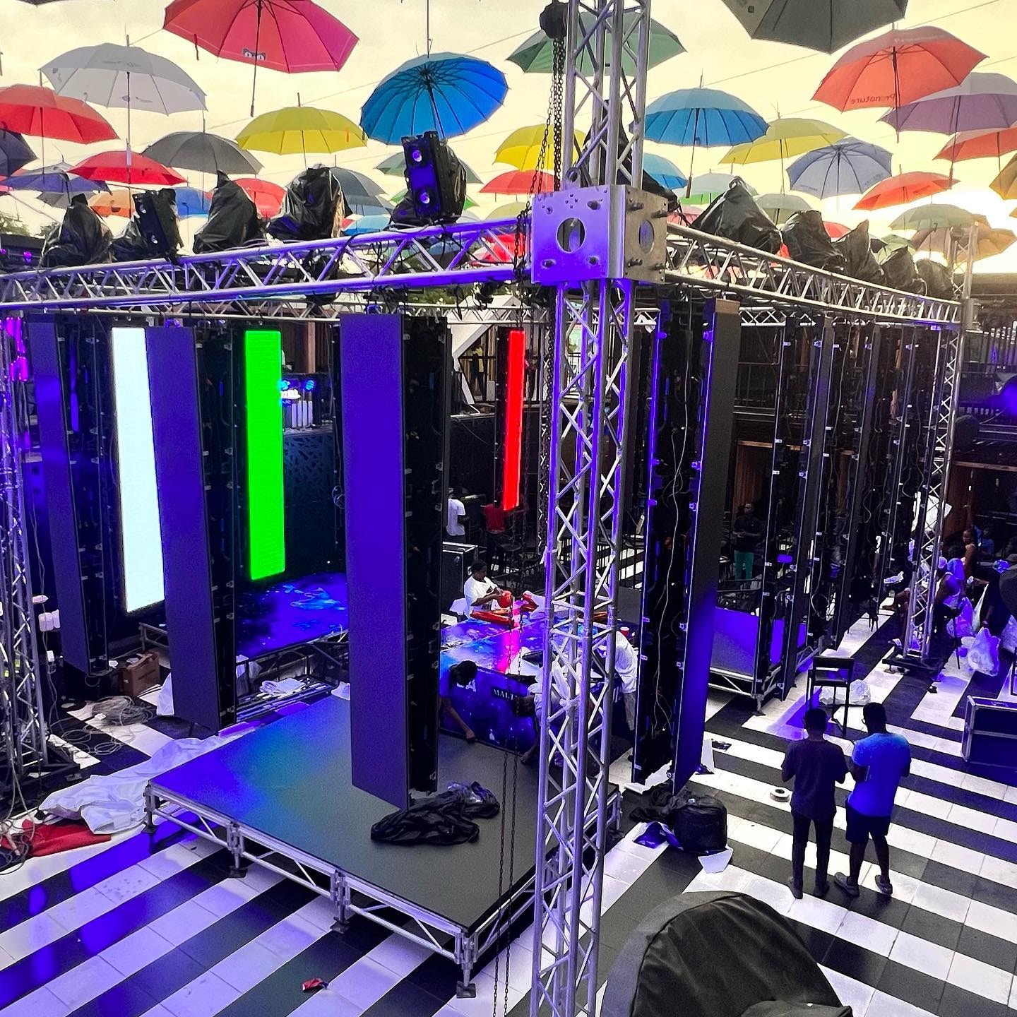 Crew working among vertical LED panels and stage truss